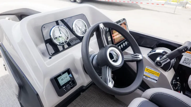 Slide: The Image of The image shows the helm of a Barletta ARIA 22QC boat with modern instruments. - 18