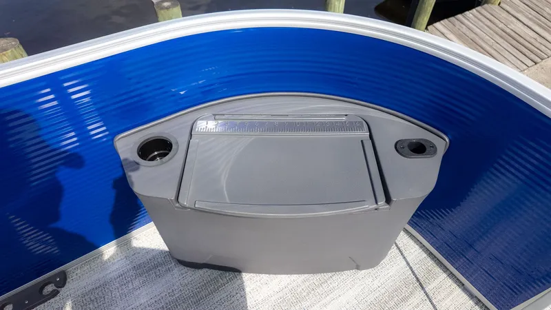 Slide: The Image of A gray fishing box with cup holders on a blue boat. - 14