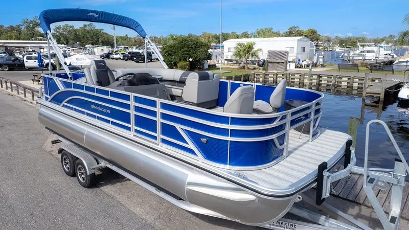 The Image of 2026 Bennington 22 S 4 PT Fishing pontoon boat on a trailer at the dock. - 1