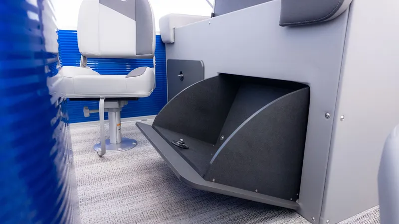 Slide: The Image of Close-up of a Bennington 22 S 4 PT Fishing boat interior with gray seats and blue accents. - 9