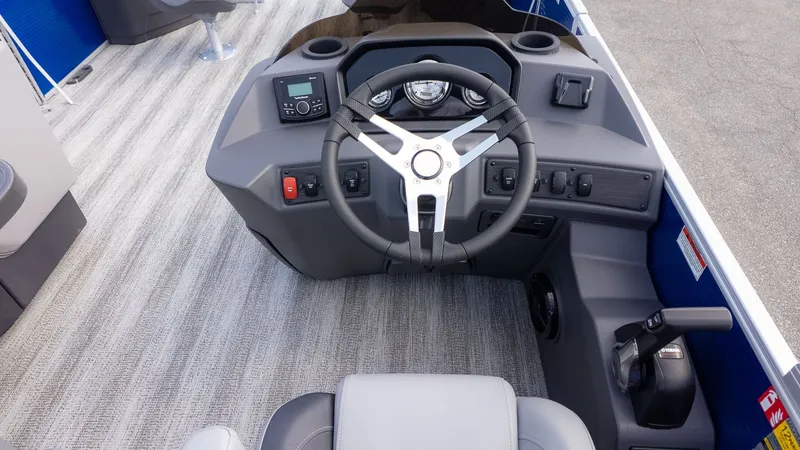 Slide: The Image of The image shows the helm of a Bennington 22 S 4 PT Fishing boat with modern controls. - 19