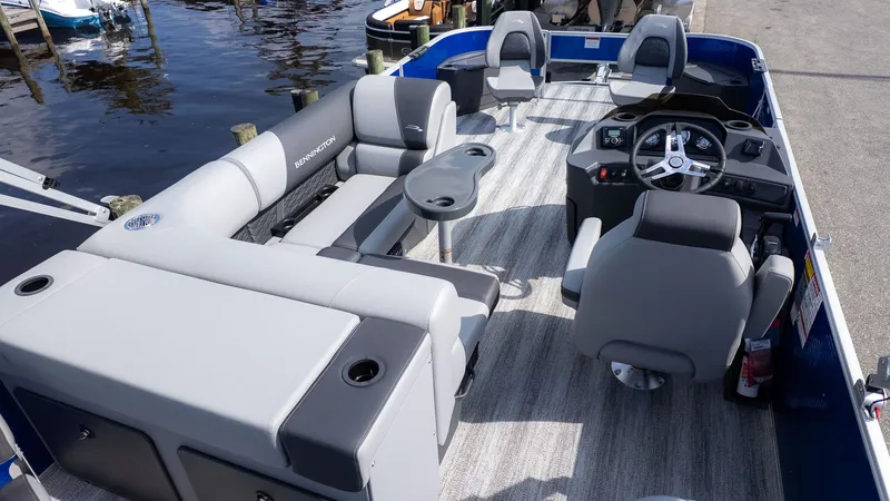 Slide: The Image of The image shows the interior of a 2026 Bennington 22 S 4 PT Fishing boat with gray seating and a helm. - 3