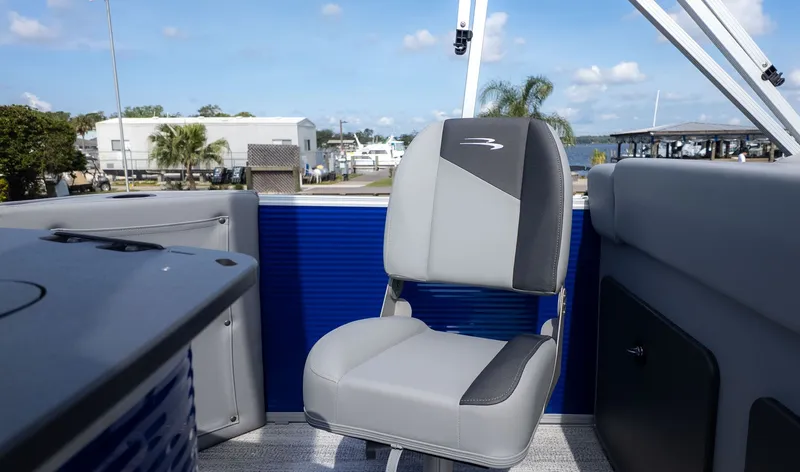 Slide: The Image of A modern boat seat with gray and black upholstery, surrounded by blue panels and a clear sky. - 4