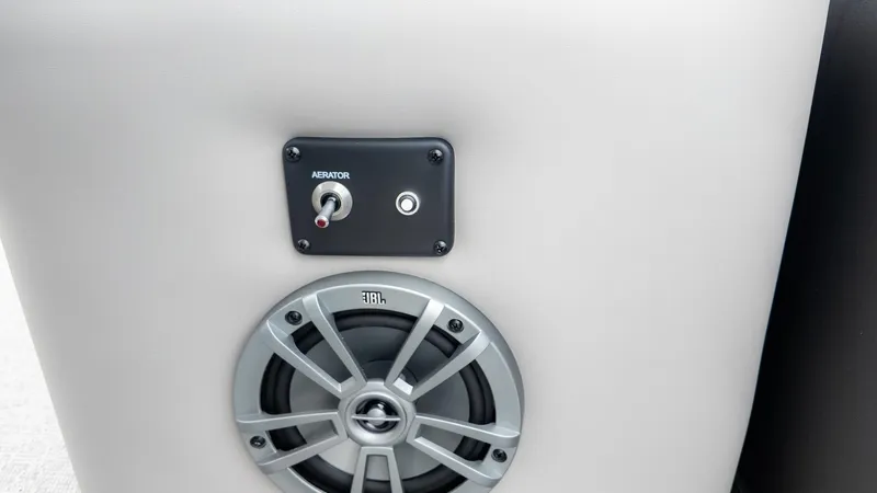 Slide: The Image of Close-up of a speaker and switch on a 2026 Barletta Aria A22CC boat. - 9