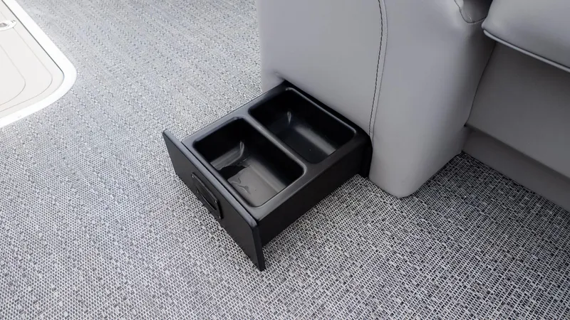 Slide: The Image of A double cup holder is integrated into the boat's floor, surrounded by gray carpet. - 15