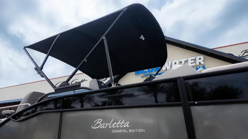 Slide: The Image of Barletta Aria A22CC 2026 with a black sunshade, in front of a building with blue accents. - 25