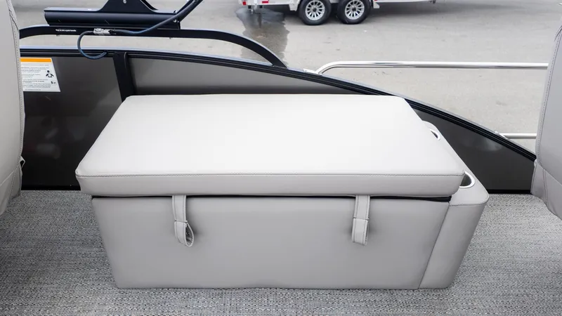 Slide: The Image of A cushioned bench seat on a boat with gray carpet flooring. - 6