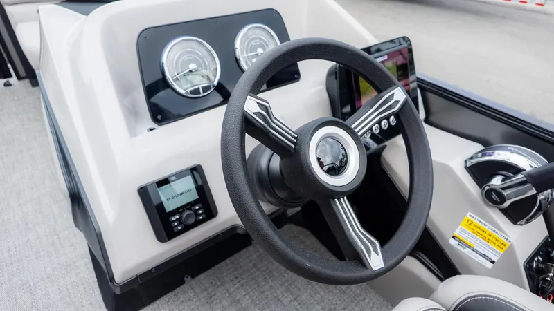 Slide: The Image of Dashboard of a Barletta Aria A22CC boat with steering wheel and instruments. - 22