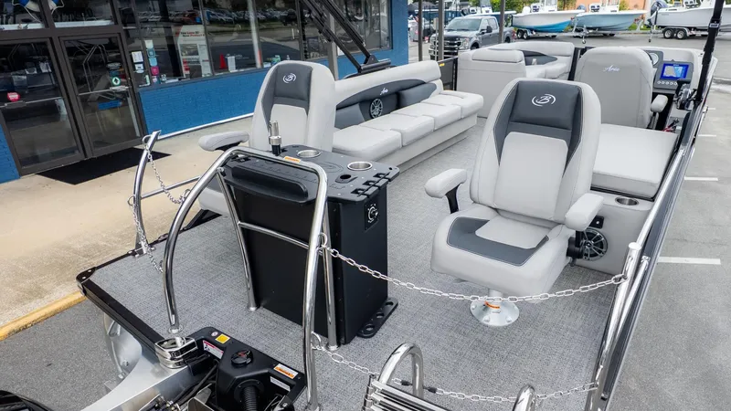 Slide: The Image of The image shows the deck of a Barletta Aria A22CC boat with gray seats and a helm console. - 4