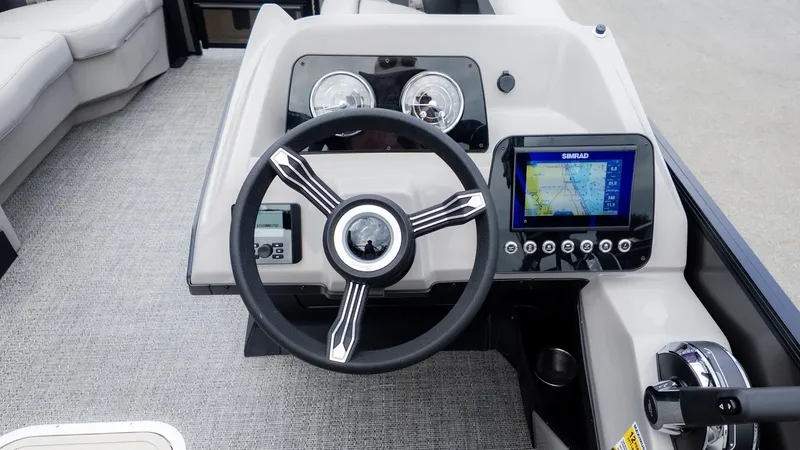 Slide: The Image of The image shows the helm of a Barletta Aria A22CC boat with a modern navigation system. - 21