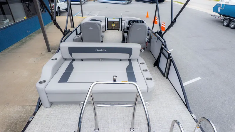 Slide: The Image of The image shows the deck of a Barletta ARIA 22UC boat with gray seating and a helm station. - 5