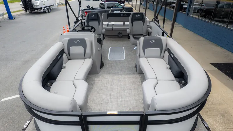 Slide: The Image of The image shows the interior of a Barletta ARIA 22UC pontoon boat with gray seating. - 3