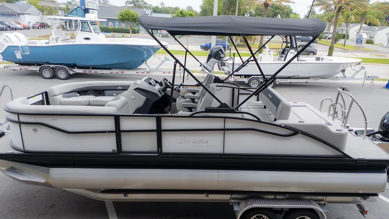 Slide: The Image of 2026 Barletta ARIA 22UC on a trailer, featuring a gray canopy and sleek interior. - 3
