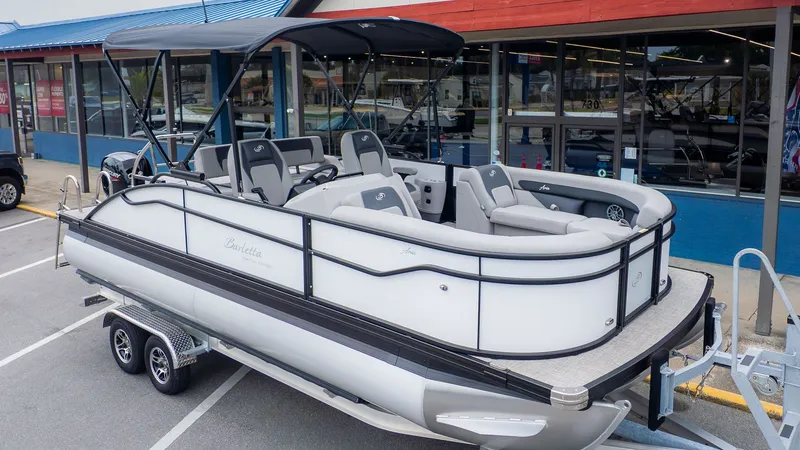 Slide: The Image of A Barletta ARIA 22UC pontoon boat on a trailer in front of a building. - 27