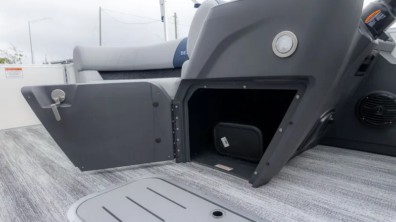 Slide: The Image of Interior of a Bennington 21 S Fish and Cruise boat with gray flooring and storage space. - 17