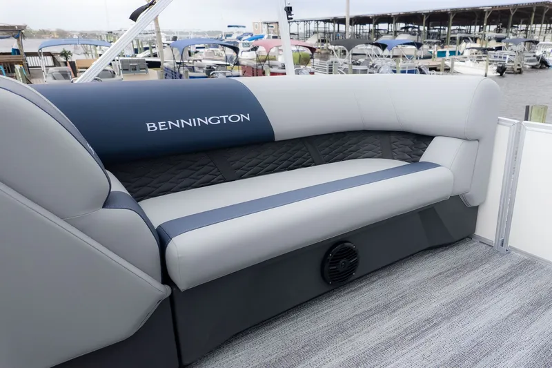 Slide: The Image of Bennington 21 S Fish and Cruise with gray and blue seating area at the marina. - 13