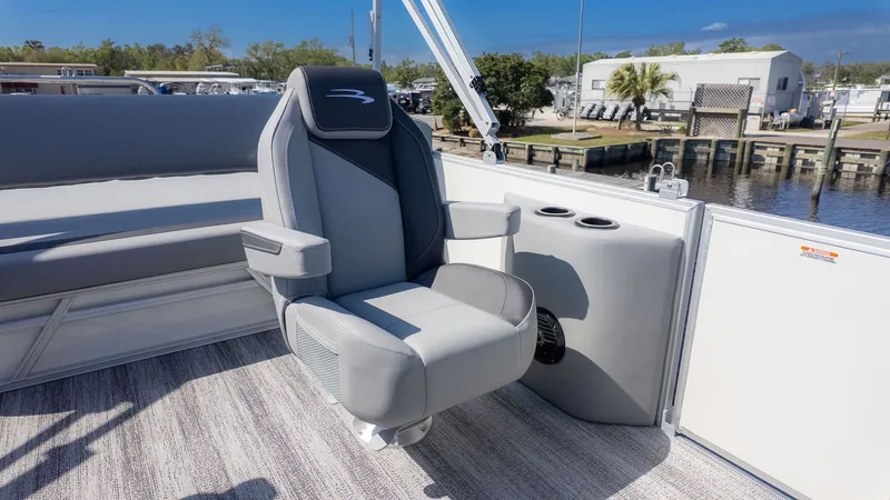 Slide: The Image of A modern boat seat with armrests on a pontoon boat, surrounded by water and a dock. - 7