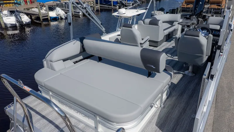 Slide: The Image of The image shows a modern pontoon boat with gray upholstery and a spacious deck. - 3