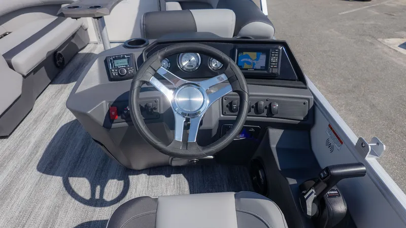 Slide: The Image of The image shows the helm of a Bennington 21 S Swingback boat with modern instruments. - 17