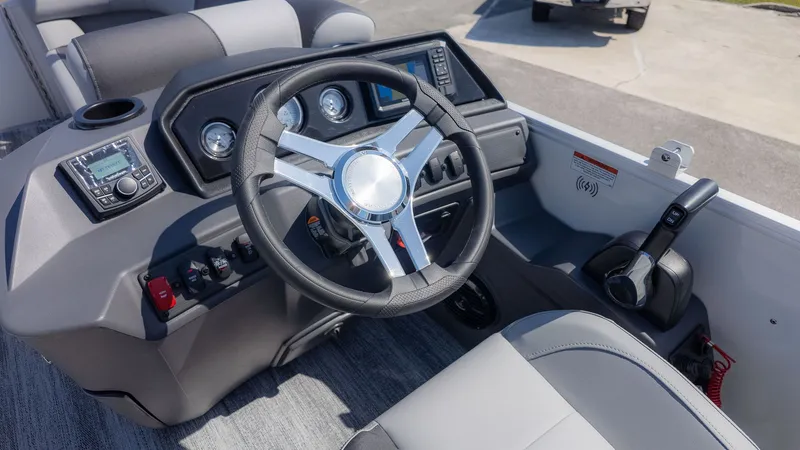 Slide: The Image of The image shows the helm of a 2026 Bennington 21 S Swingback boat with a modern steering wheel. - 16