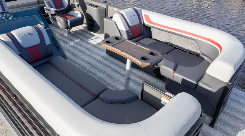 Slide: The Image of Interior of a Bennington 22 S Swingback with gray and white seating, table, and cup holders. - 3