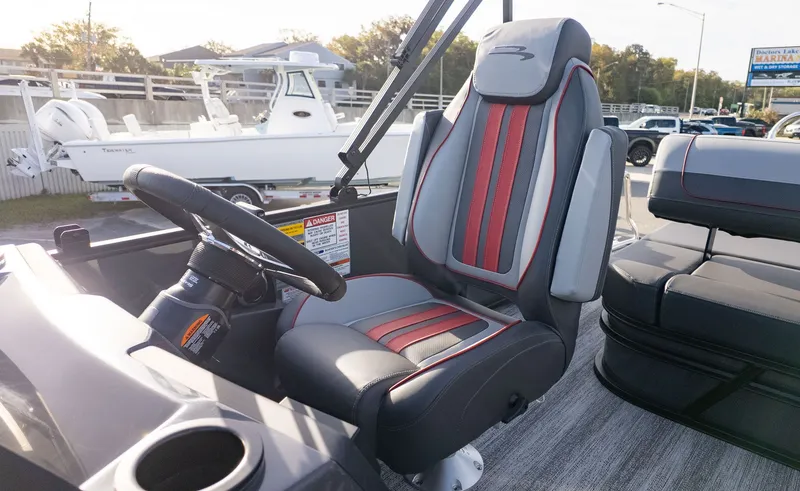 Slide: The Image of The Bennington 22 S Swingback features a modern seat with red and gray accents. - 8