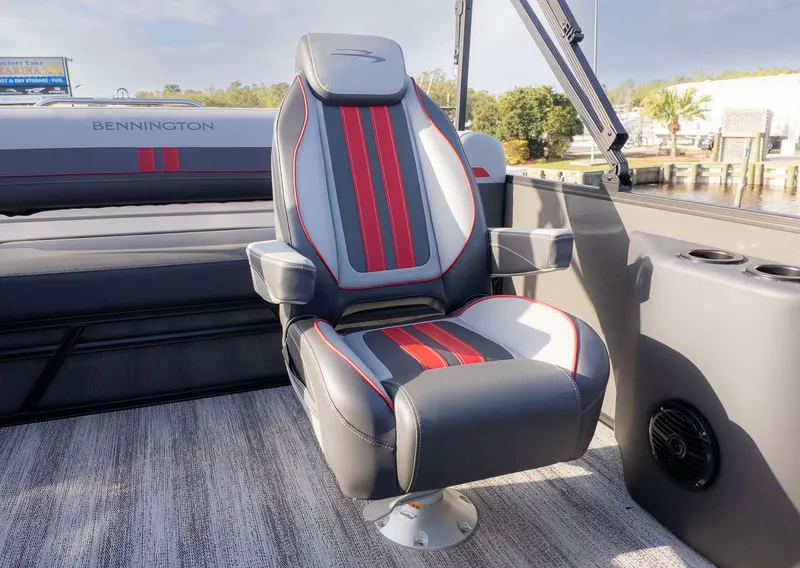 Slide: The Image of A luxurious captain's chair with red and gray accents on a Bennington boat. - 6
