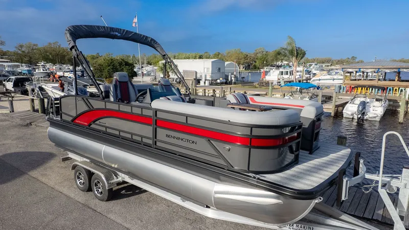 Slide: The Image of A Bennington 22 S Swingback pontoon boat on a trailer, ready for launch, featuring a modern design. - 20