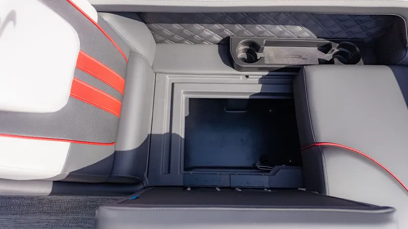 Slide: The Image of Close-up of a seating area with storage compartment and cup holders. - 12