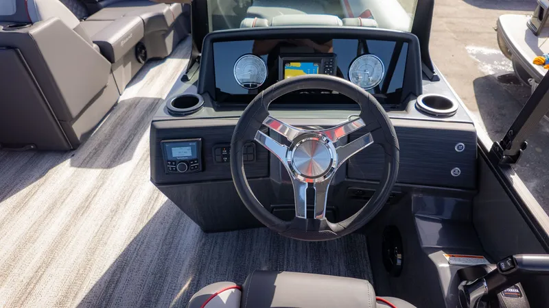 Slide: The Image of The image shows the cockpit of a Bennington 22 S Swingback boat with a modern steering wheel and instruments. - 17
