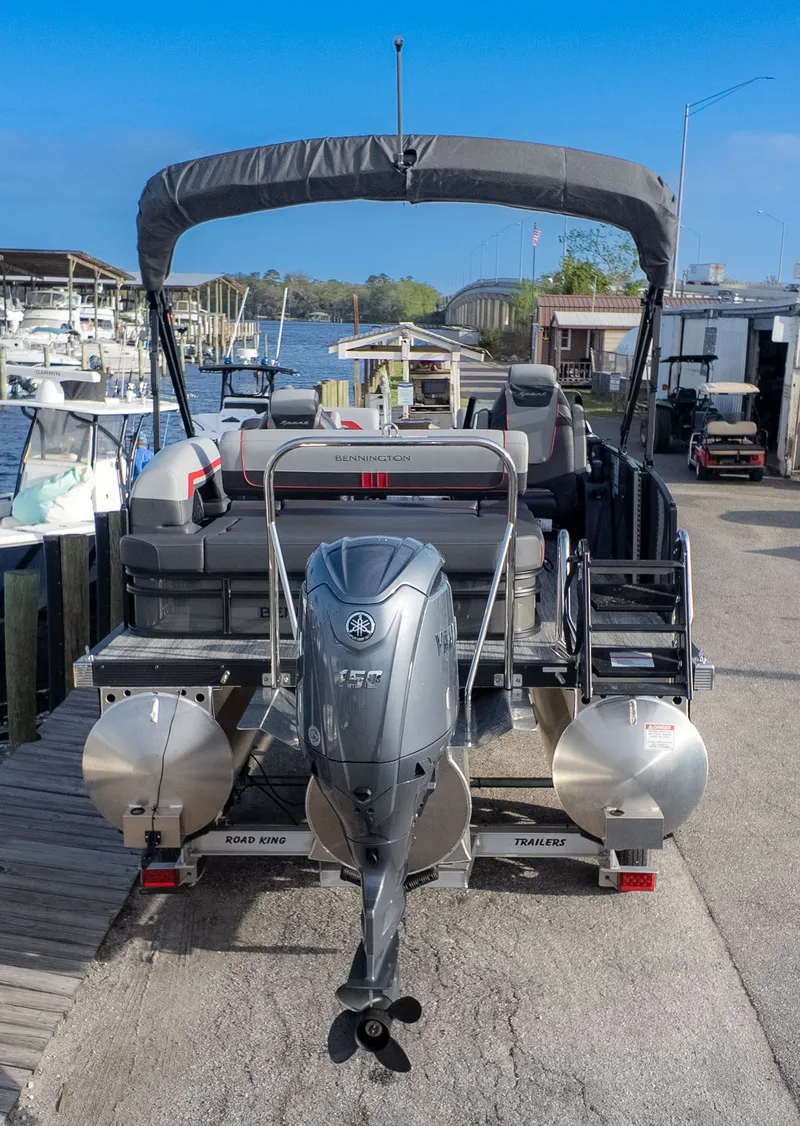 The Image of 2026 Bennington 22 S Swingback at dock with outboard motor. - 1