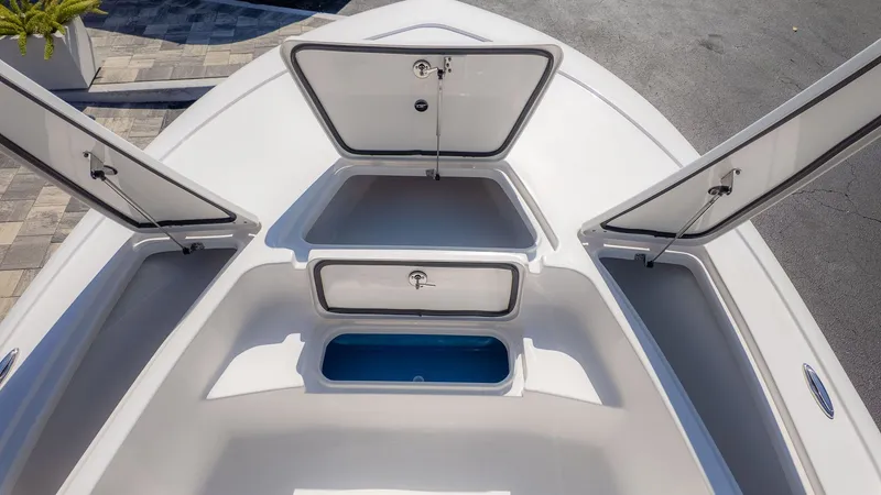 Slide: The Image of The image shows the bow of a Tidewater 2110 Bay Max boat with open storage compartments. - 9