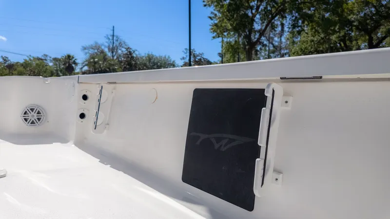 Slide: The Image of Interior view of a Tidewater 2110 Bay Max boat with white walls and a black panel. - 5