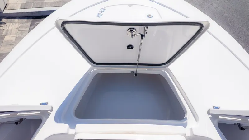 Slide: The Image of The image shows an open storage compartment on a boat, surrounded by white decking. - 12