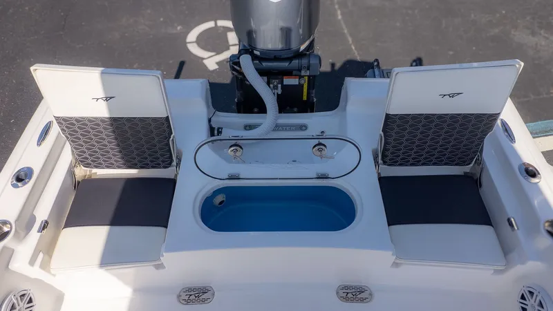 Slide: The Image of The image shows the stern of a Tidewater 2110 Bay Max boat with two seats and a blue livewell. - 4