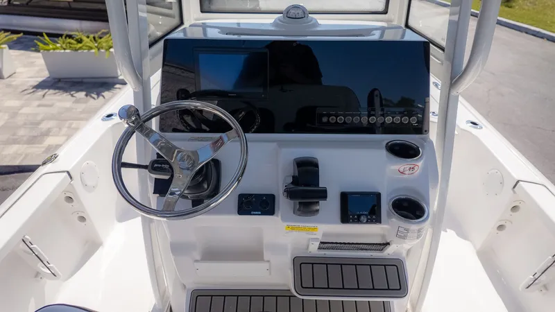 Slide: The Image of The image shows the helm of a 2026 Tidewater 2110 Bay Max boat. - 17