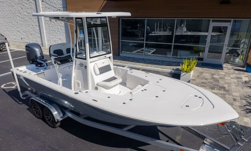 Slide: The Image of A modern Tidewater 2110 Bay Max on a trailer in front of a building. - 18