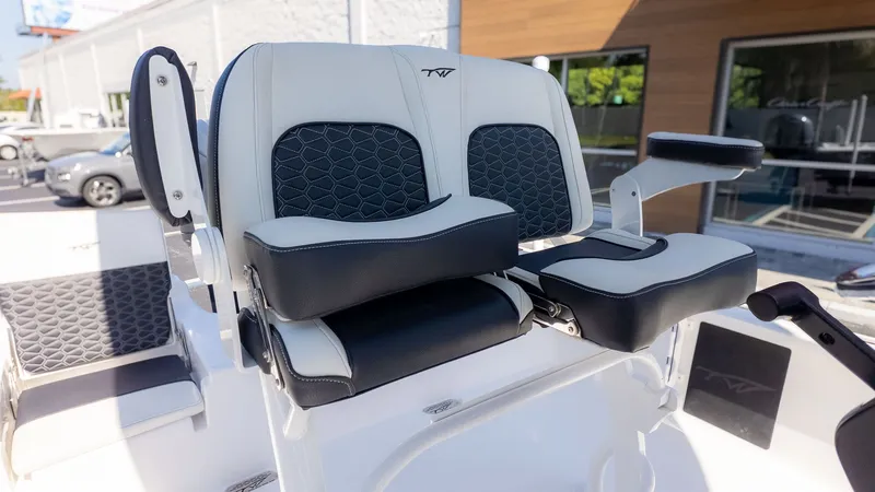 Slide: The Image of The image shows the seats of a Tidewater 2110 Bay Max boat with black and white upholstery. - 14