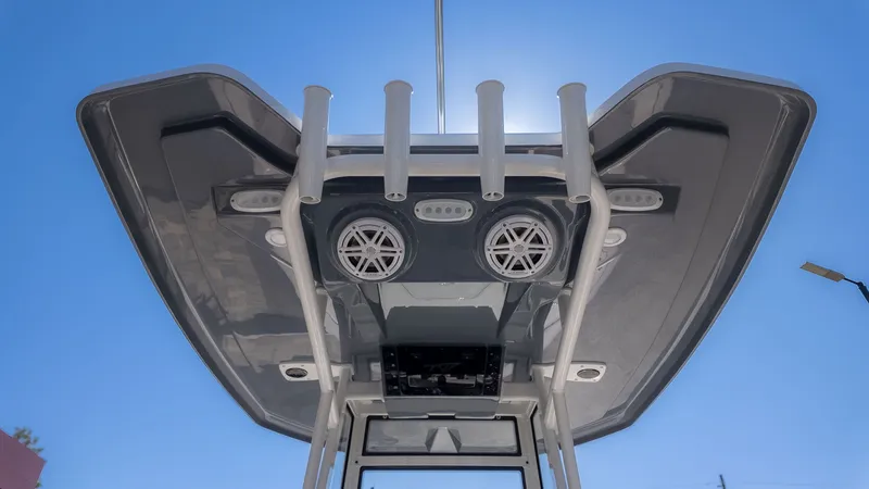 The Image of View of a boat's T-top with speakers and fishing rod holders. - 1