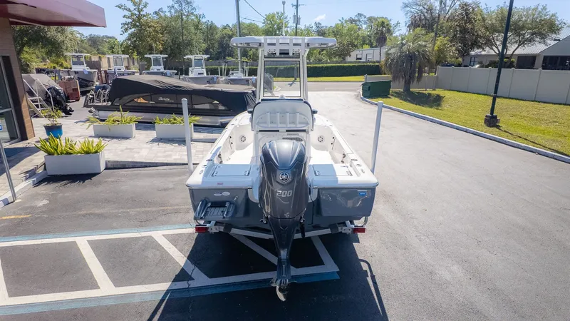 Slide: The Image of The image shows a Tidewater 2110 Bay Max boat on a trailer in a parking lot. - 19