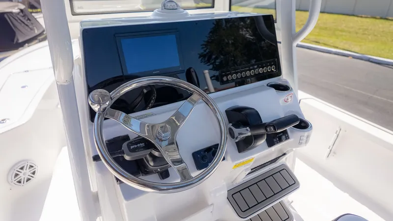 Slide: The Image of The image shows the helm of a Tidewater 2110 Bay Max boat with modern controls. - 15