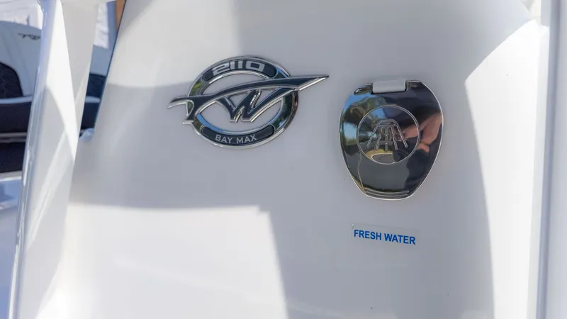 Slide: The Image of Close-up of the logo and fresh water connection on a Tidewater 2110 Bay Max boat. - 13