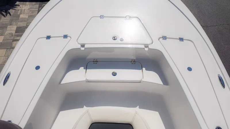 Slide: The Image of The image shows the bow deck of a Tidewater 2110 Bay Max boat with storage hatches. - 7