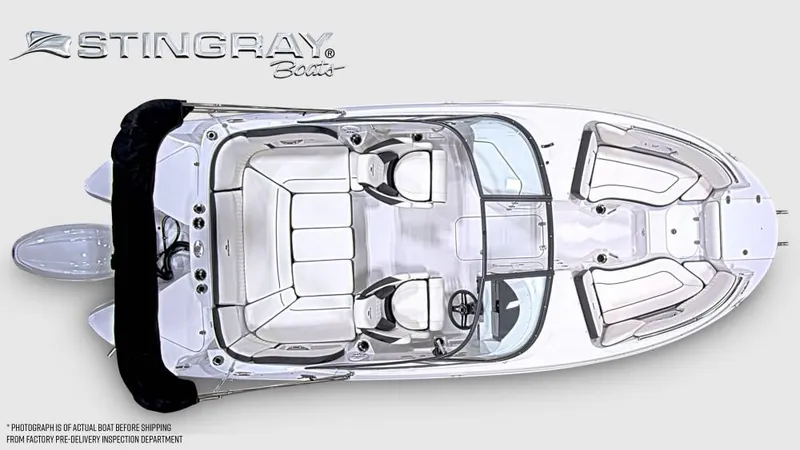 Slide: The Image of Stingray 211 DC from above, showing seating and helm. Sleek design with white interior. - 7
