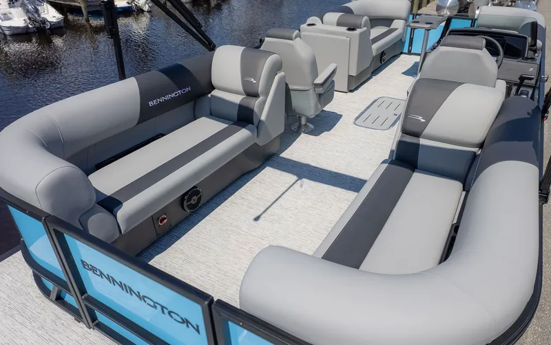 Slide: The Image of The image shows the spacious deck of a Bennington 22 S STERN RADIUS pontoon boat with gray seating. - 3