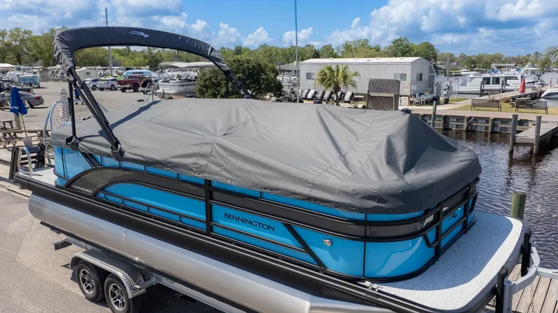 Slide: The Image of A Bennington pontoon boat, model 22 S STERN RADIUS, on a trailer at the marina. - 24