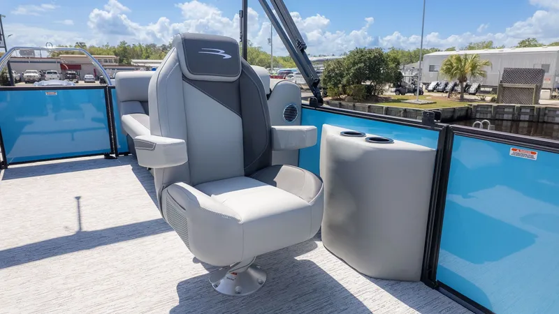 Slide: The Image of Bennington 22 S STERN RADIUS 2026: Luxurious seating with blue panels and cup holders. - 9