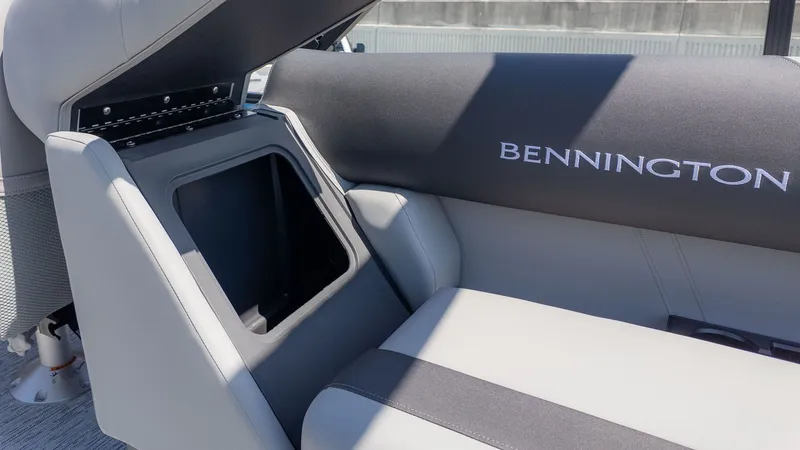 Slide: The Image of Interior view of a Bennington boat with gray upholstery and storage space. - 4
