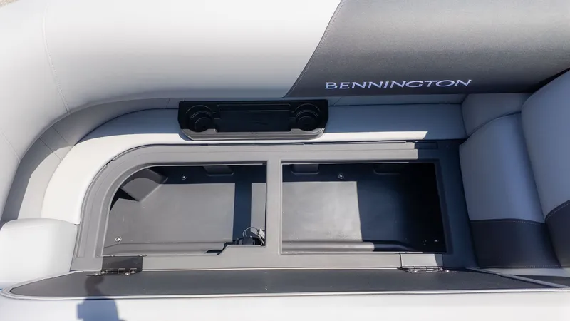 Slide: The Image of The image shows a seating area with storage on a Bennington boat. - 17