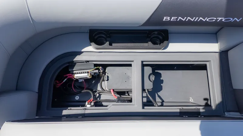 Slide: The Image of The image shows the storage compartment of a Bennington 22 S STERN RADIUS boat with electrical connections. - 7